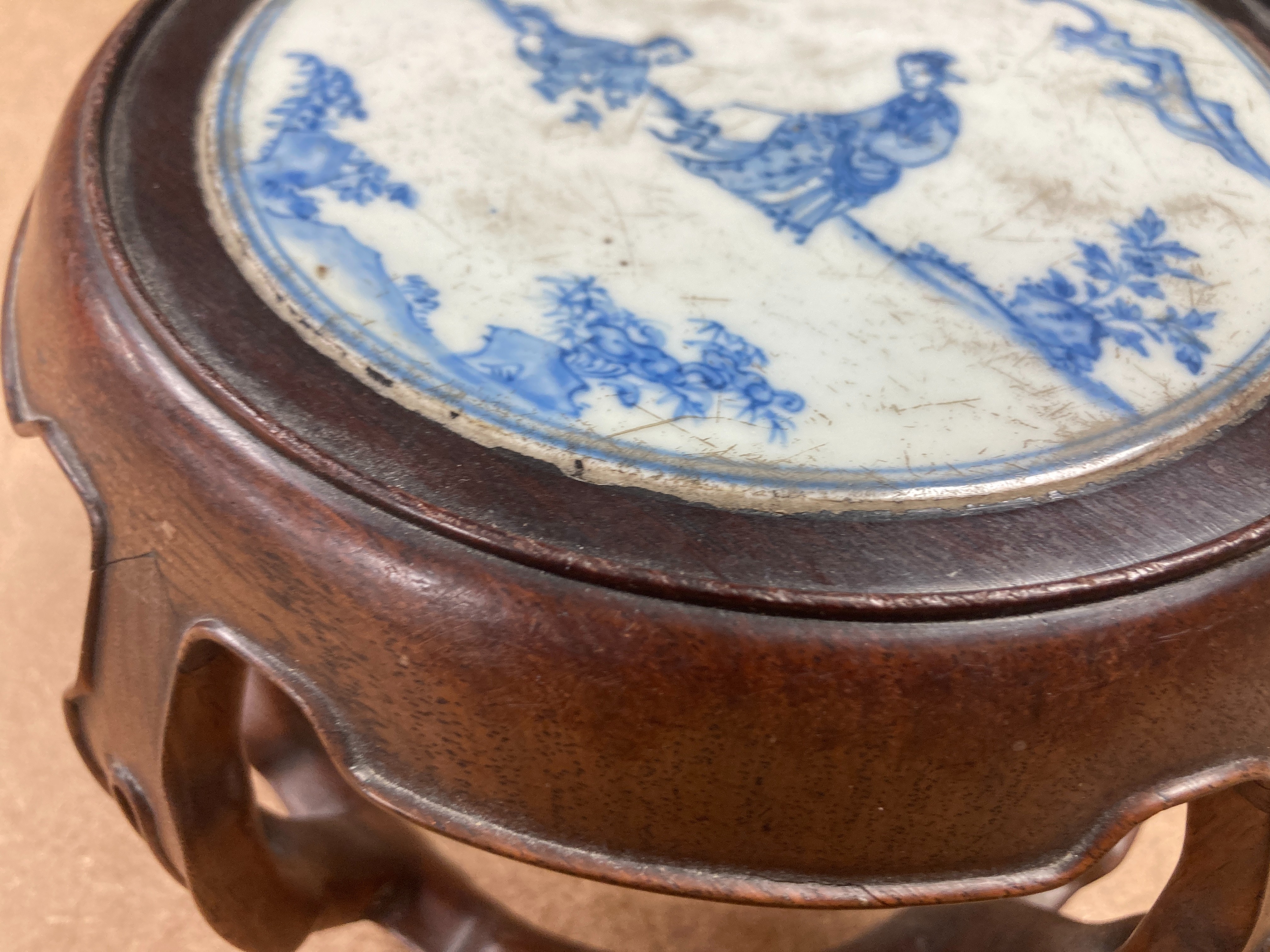 A 19th century Chinese blue and white circular tile inset hongmu stand, 22cm